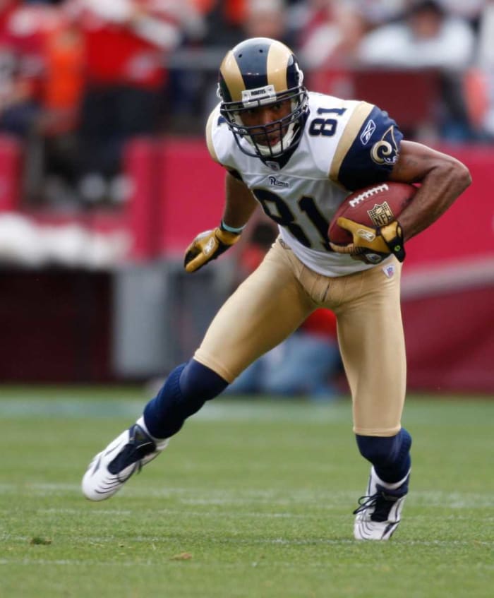 Rams receiver Torry Holt looks for space after making a catch. He caught more than 90 passes in a season six times.